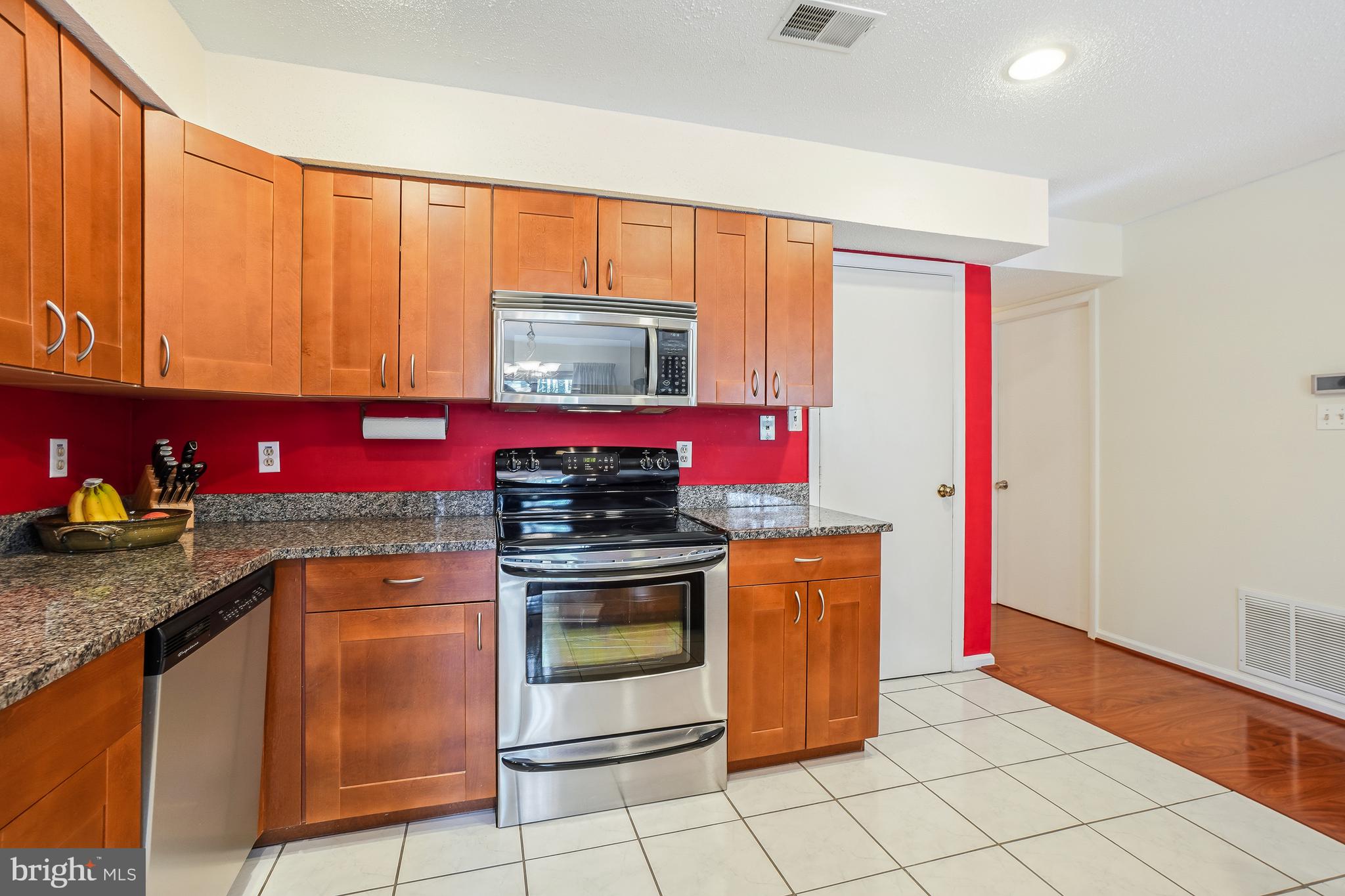 2315 Glade Bank Way Reston, VA 20191 - Photo 8 of 52 a kitchen with stainless steel appliances granite countertop a stove a sink and a microwave