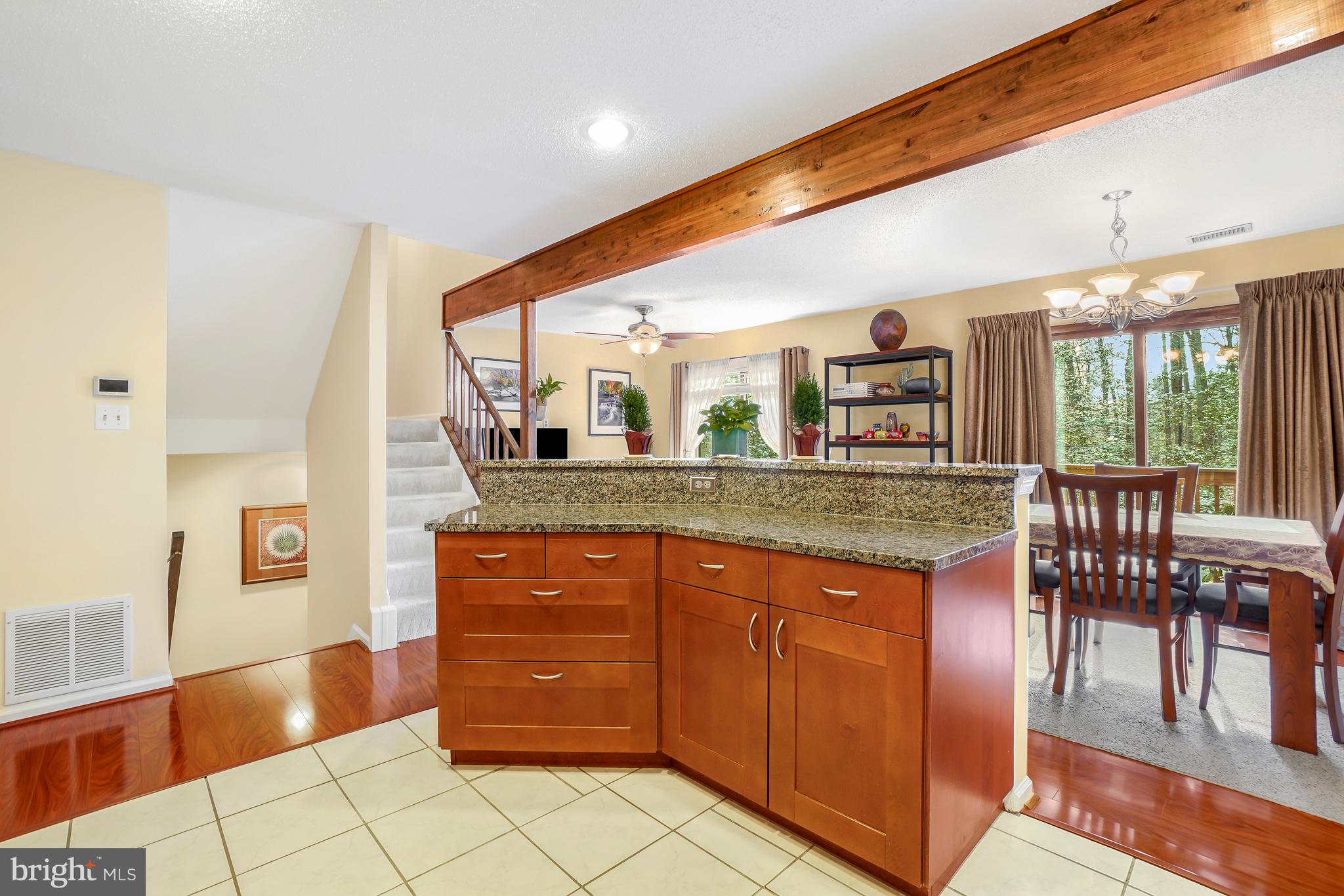 2315 Glade Bank Way Reston, VA 20191 - Photo 9 of 52 a kitchen with stainless steel appliances granite countertop a stove a sink and a dining table