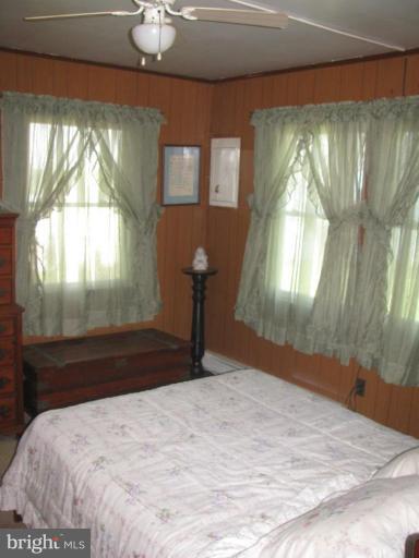 1027 Long Point Road Grasonville, MD 21638 - Photo 7 of 27 a bedroom with a bed and a chandelier