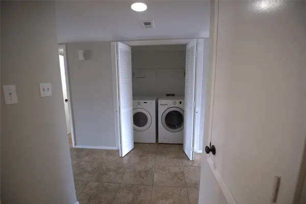 a view of a storage & utility room with a washer dryer