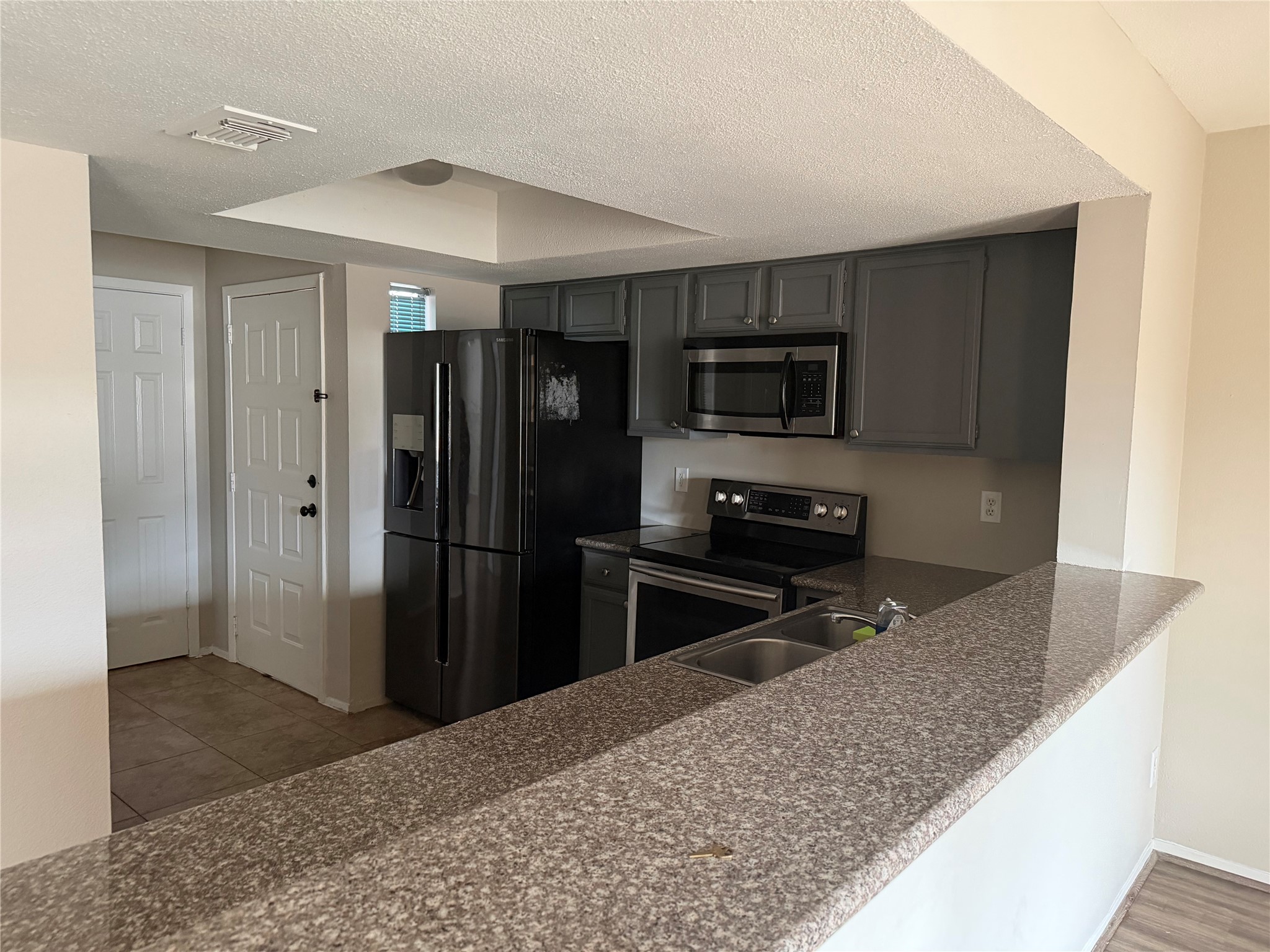 4444 Victory Drive, Unit 1208 Houston, TX 77088 - Photo 3 of 17 Another view of the kitchen next to the dinning area and balcony.