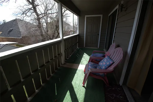 a view of balcony with wooden floor and outdoor seating