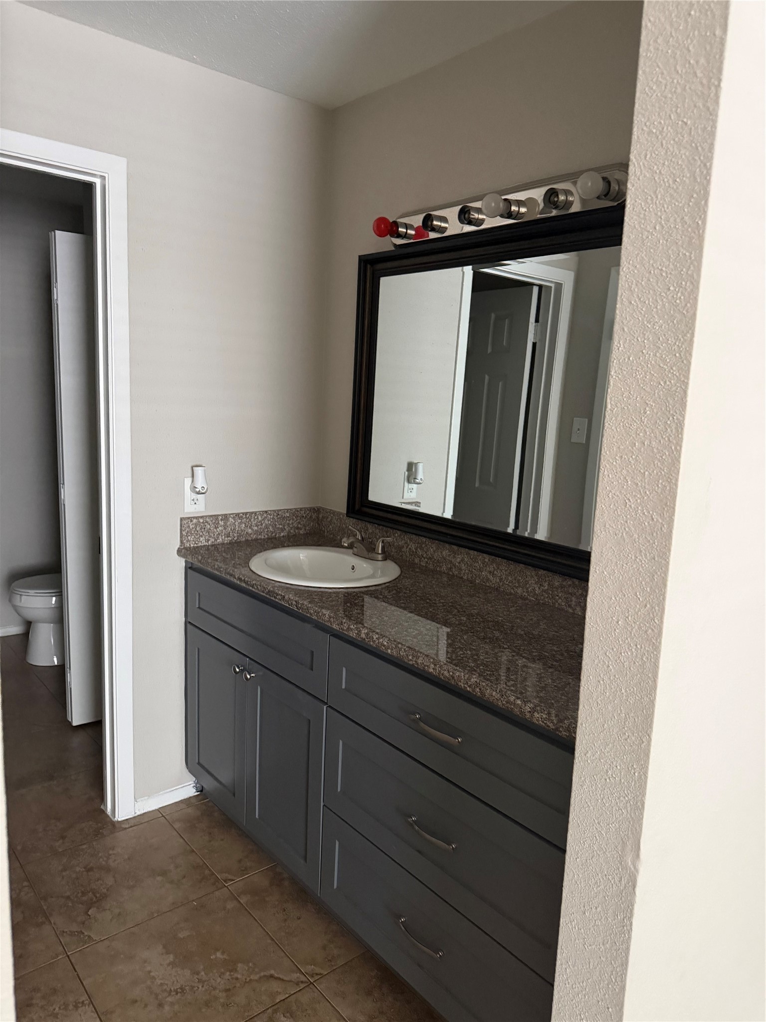 4444 Victory Drive, Unit 1208 Houston, TX 77088 - Photo 10 of 17 Master bathroom featuring granite countertops and a spacious walk-in closet, offering ample storage.