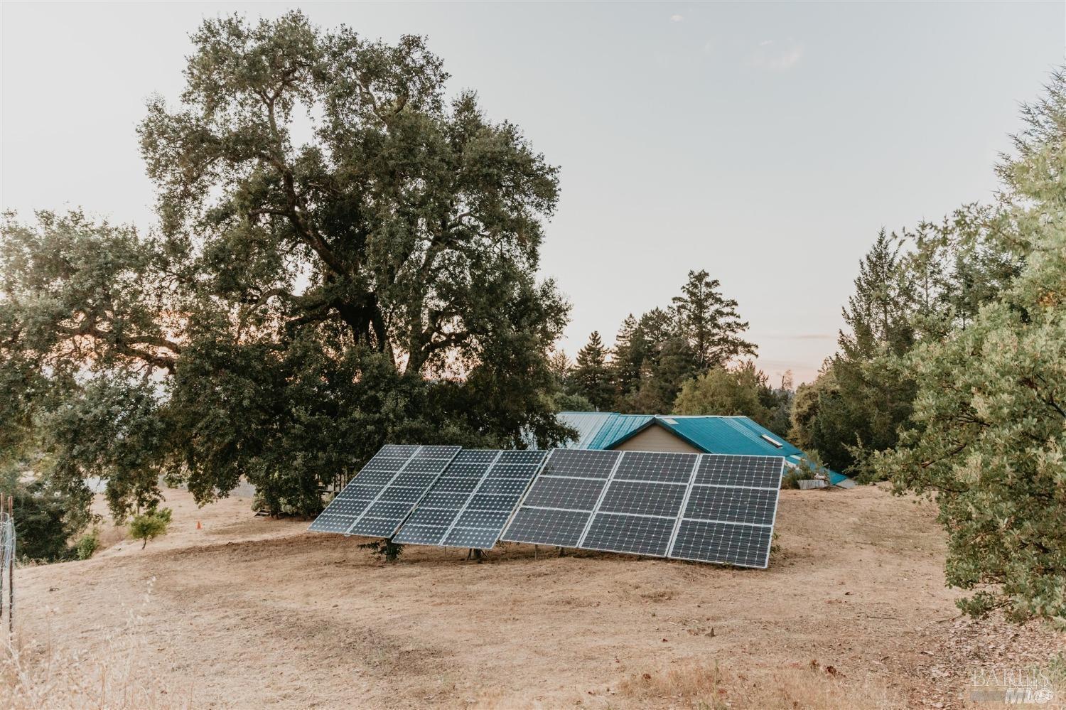 49100 Wickersham Road Geyserville, CA 95441 - Photo 20 of 98 a view of a tennis ground with large trees