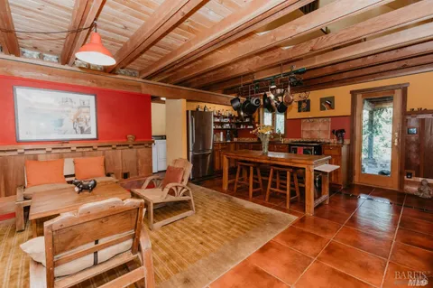 a living room with furniture a flat screen tv and large window