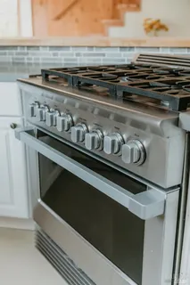 a kitchen with stainless steel appliances granite countertop a stove and a sink