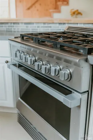 a kitchen with stainless steel appliances granite countertop a stove and a sink