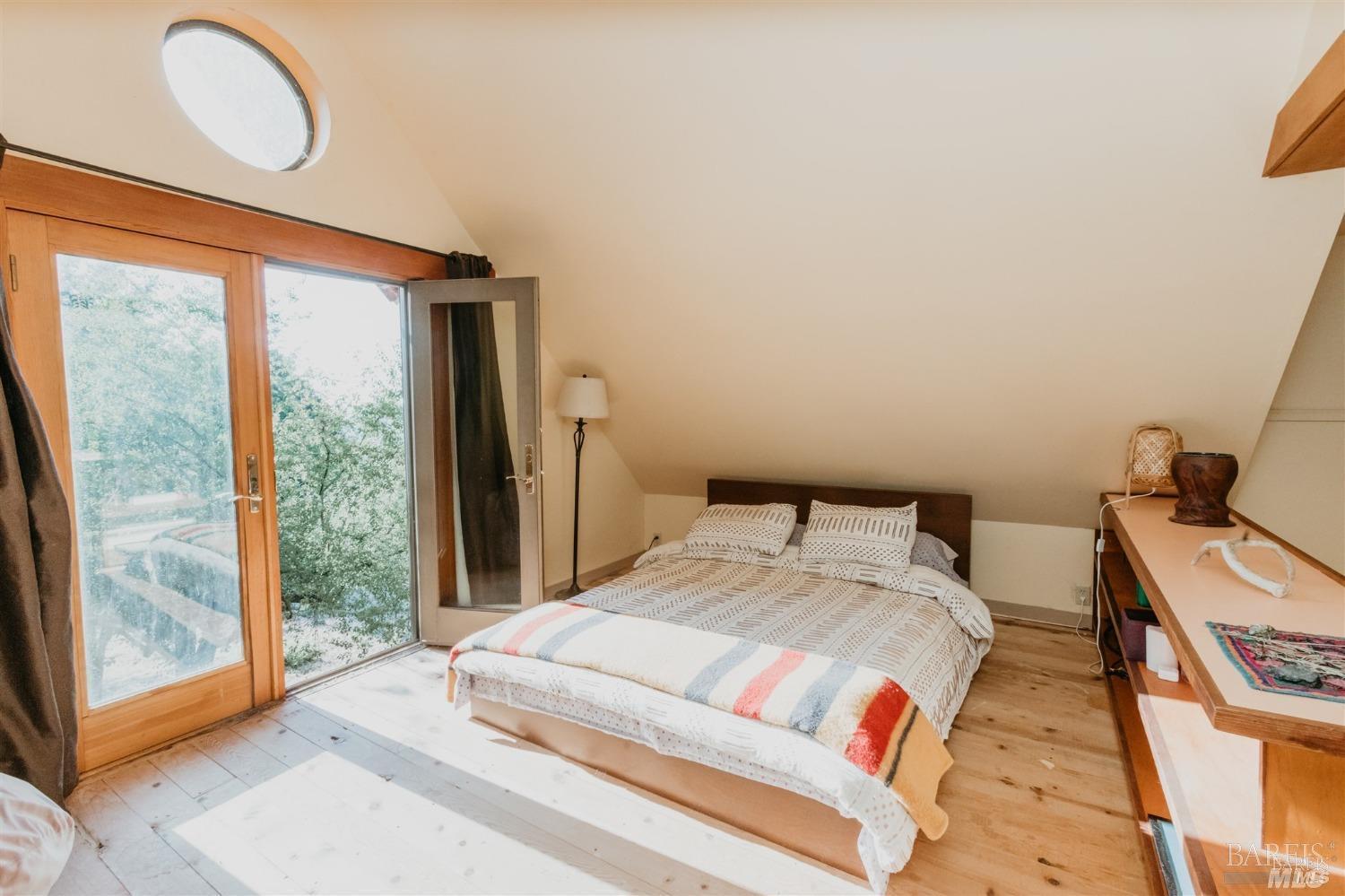 49100 Wickersham Road Geyserville, CA 95441 - Photo 35 of 98 a bedroom with a bed and large windows