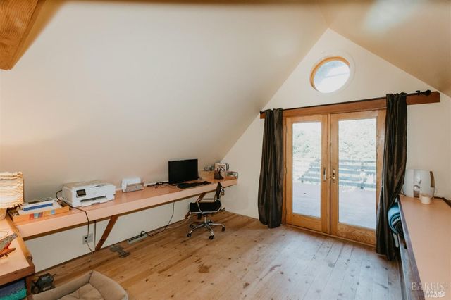 a bed sitting in a bedroom next to a window