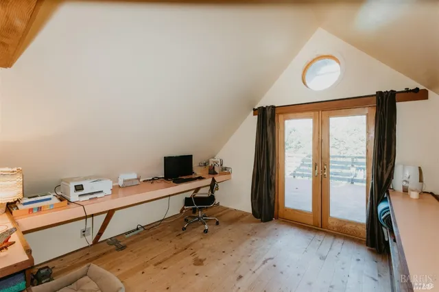 a bed sitting in a bedroom next to a window