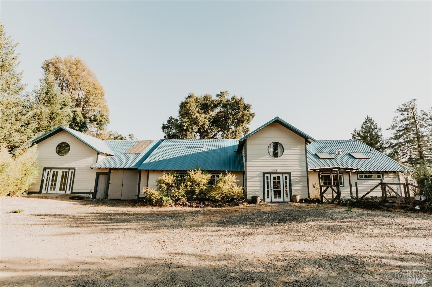 49100 Wickersham Road Geyserville, CA 95441 - Photo 45 of 98 a front view of a house with a yard and garage