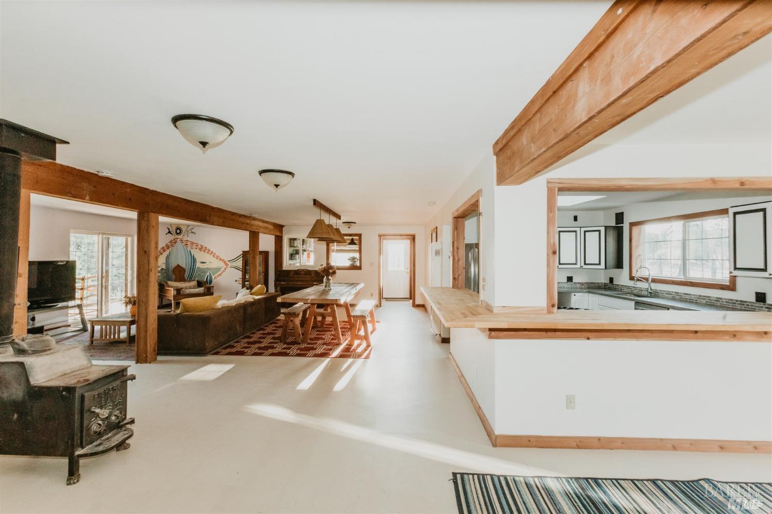 49100 Wickersham Road Geyserville, CA 95441 - Photo 48 of 98 a living room with furniture a flat screen tv and large window