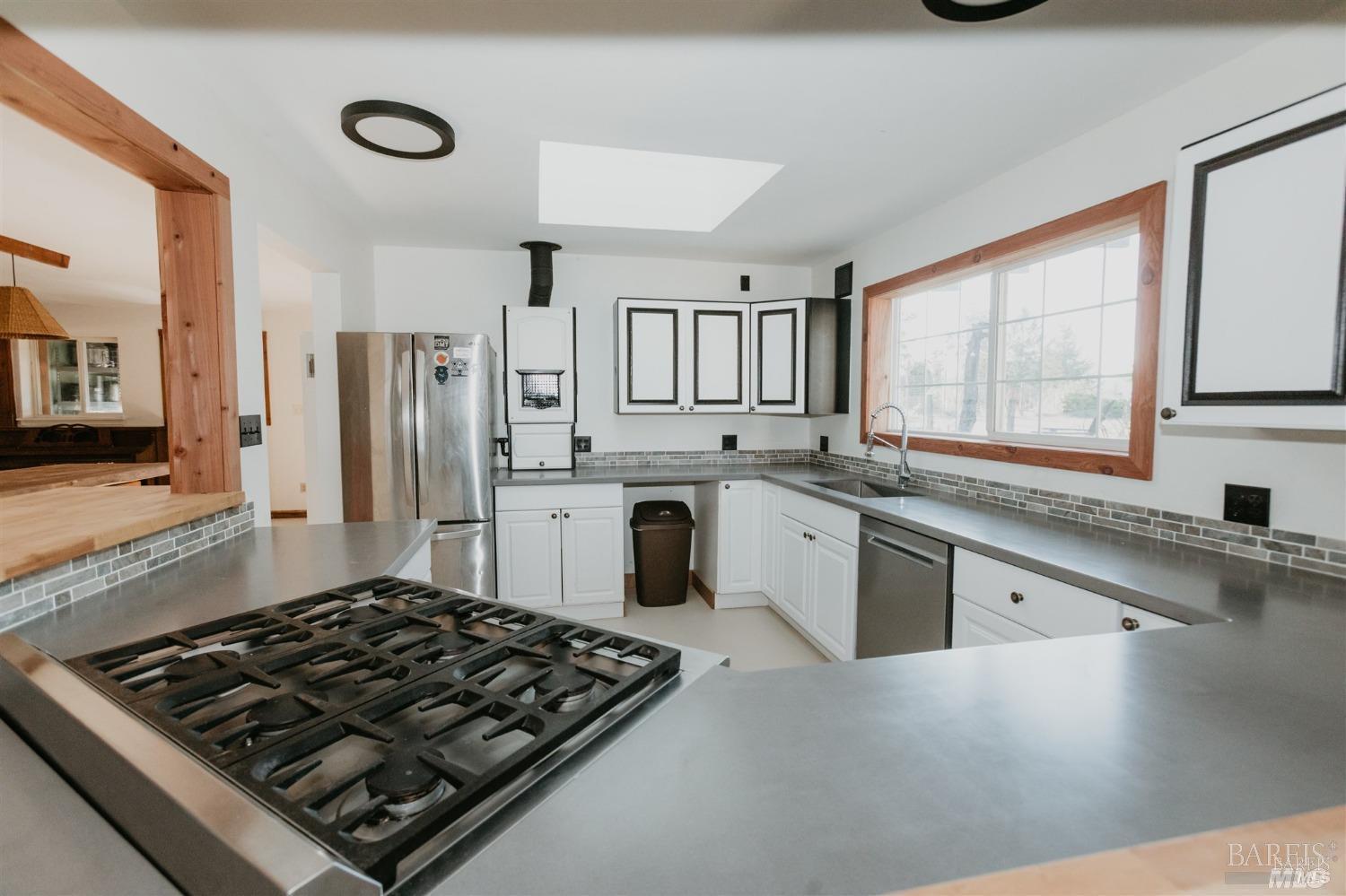 49100 Wickersham Road Geyserville, CA 95441 - Photo 49 of 98 a kitchen with stainless steel appliances granite countertop a stove a sink dishwasher and a refrigerator
