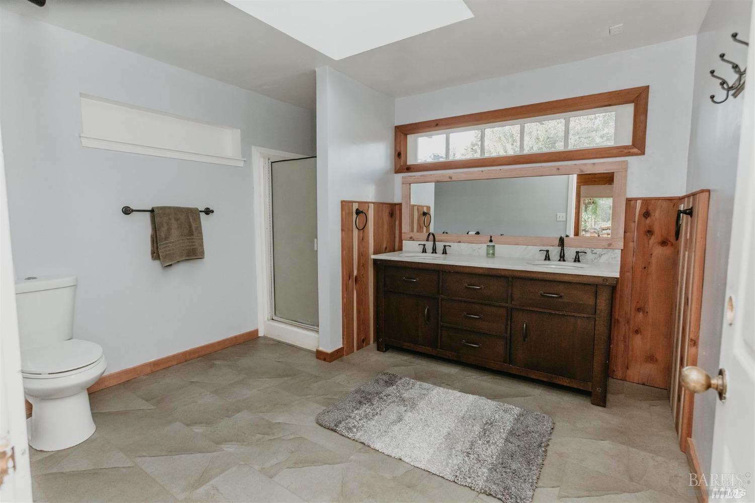 49100 Wickersham Road Geyserville, CA 95441 - Photo 55 of 98 a spacious bathroom with a sink and a mirror
