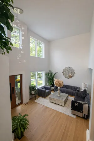 a living room with furniture and a chandelier
