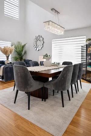 a living room with patio furniture and floor to ceiling window