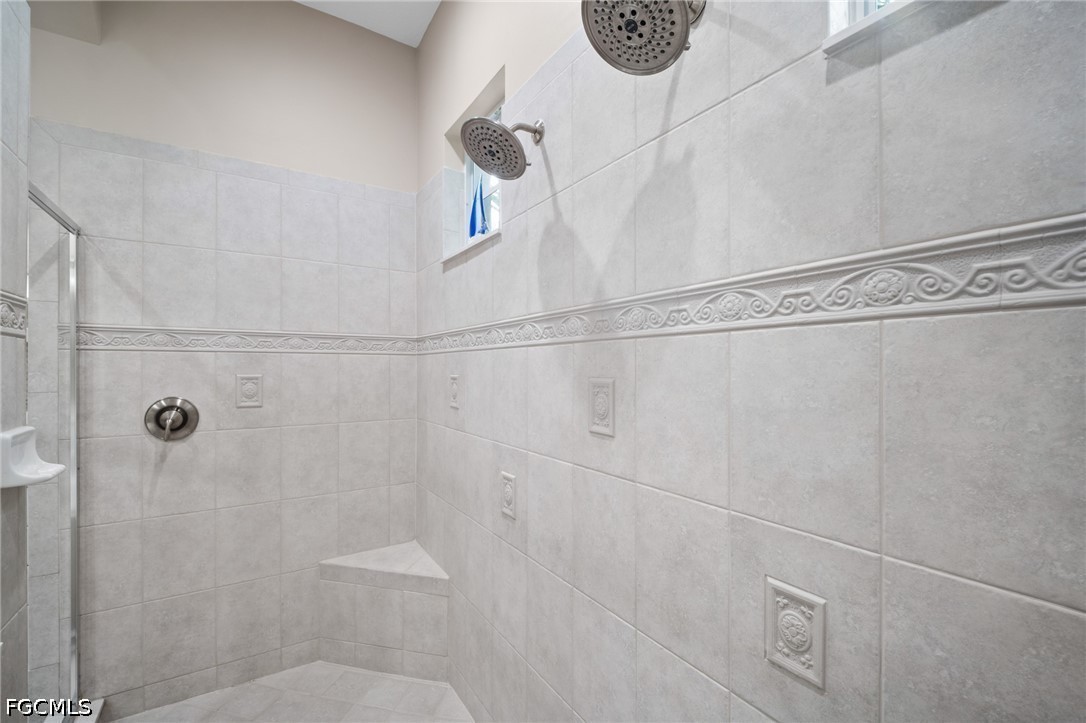 9042 Bronco Court Naples, FL 34113 - Photo 19 of 50 a bathroom with a shower and toilet
