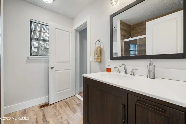 a bathroom with a sink vanity and a mirror