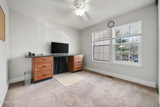 a view of workspace with furniture and flat screen tv