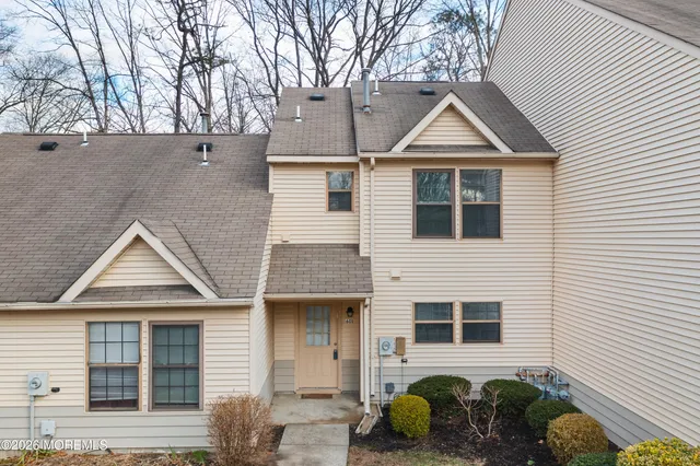 a front view of a house with plants