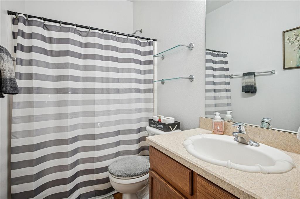 111 Freedom Trail Forney, TX 75126 - Photo 13 of 16 a bathroom with a sink toilet and shower