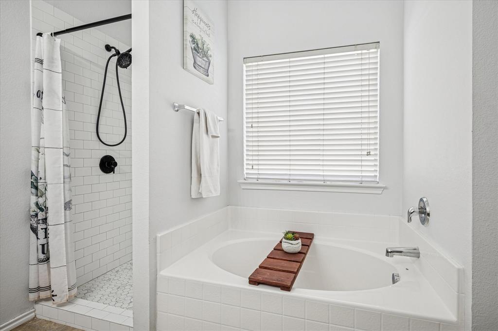 111 Freedom Trail Forney, TX 75126 - Photo 10 of 16 a bathroom with a bath tub with a shower