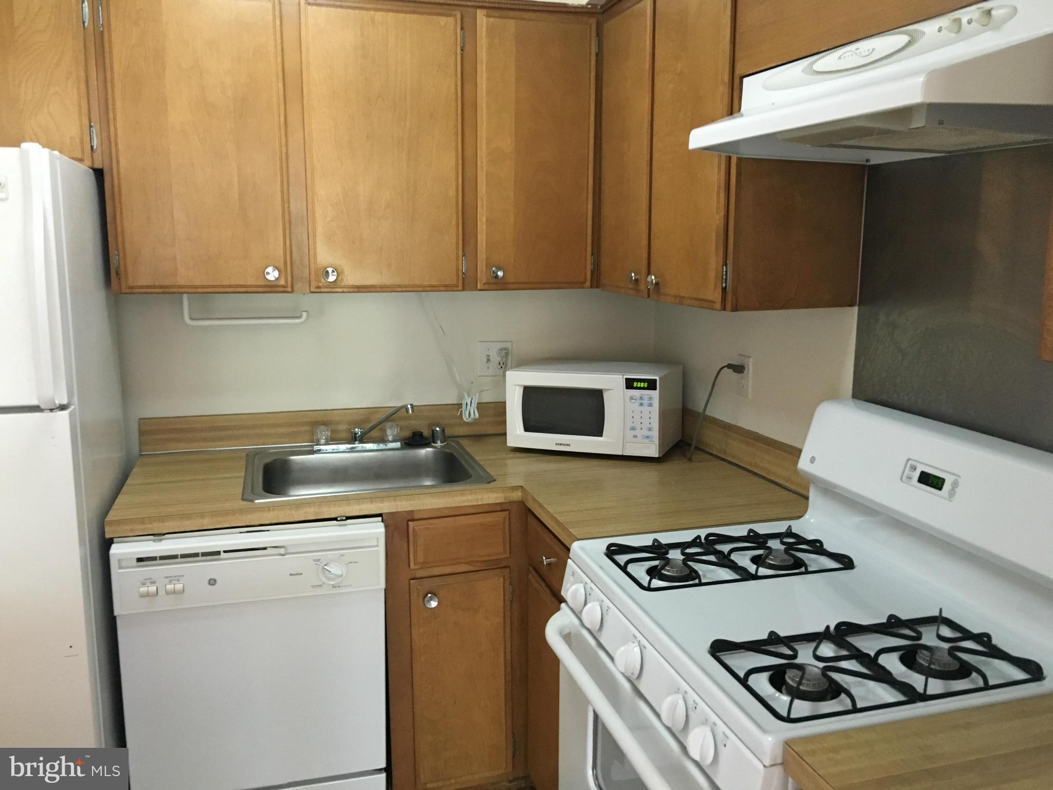 200 Cross Keys Road, Unit R65 Baltimore, MD 21210 - Photo 5 of 9 a kitchen with a stove and a refrigerator