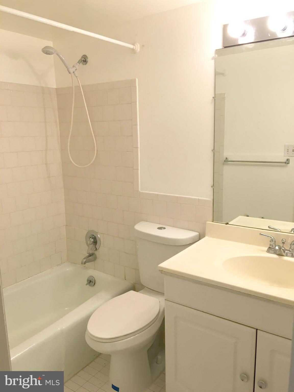 200 Cross Keys Road, Unit R65 Baltimore, MD 21210 - Photo 9 of 9 a bathroom with a sink a toilet and shower