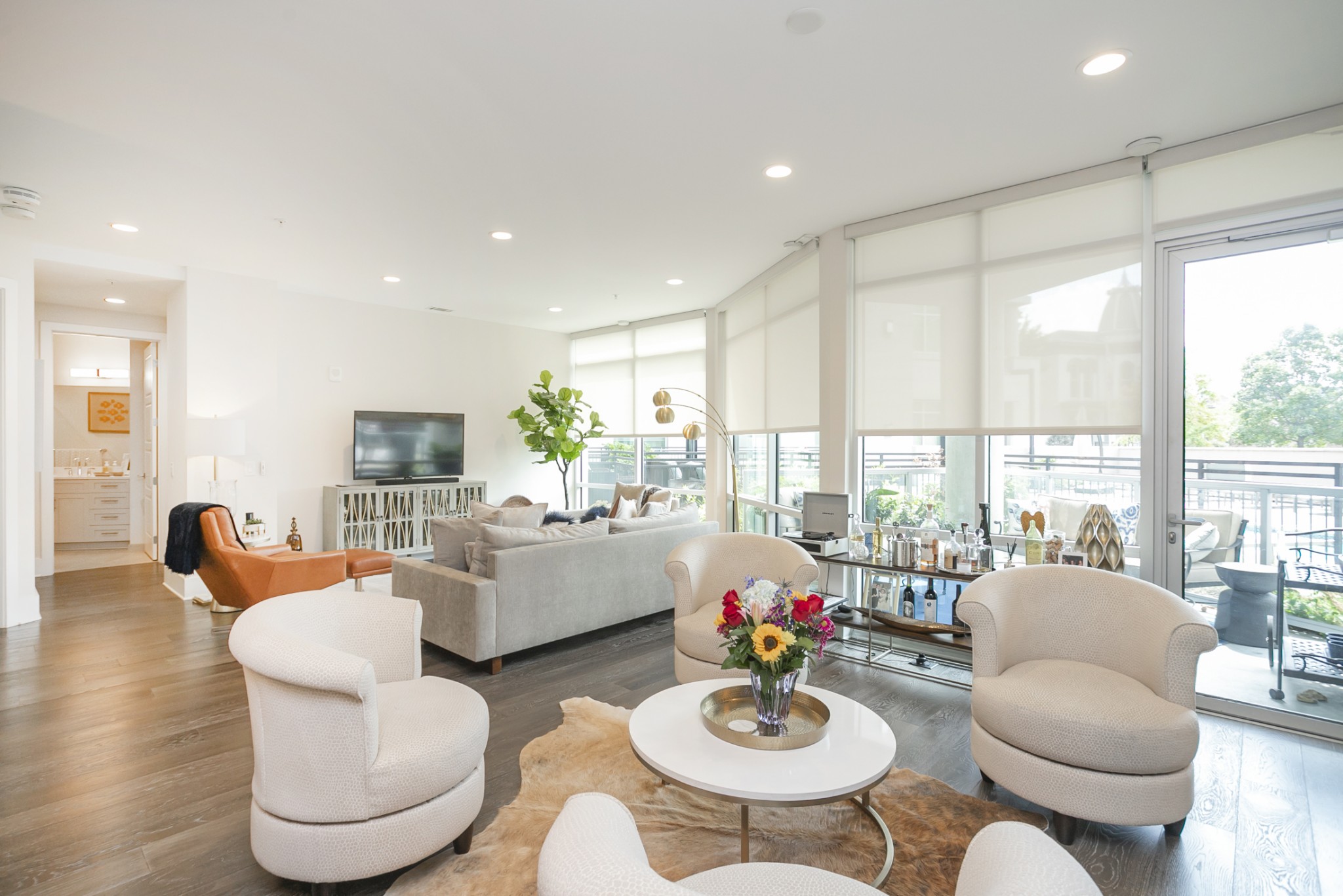 a living room with fireplace furniture and a large window