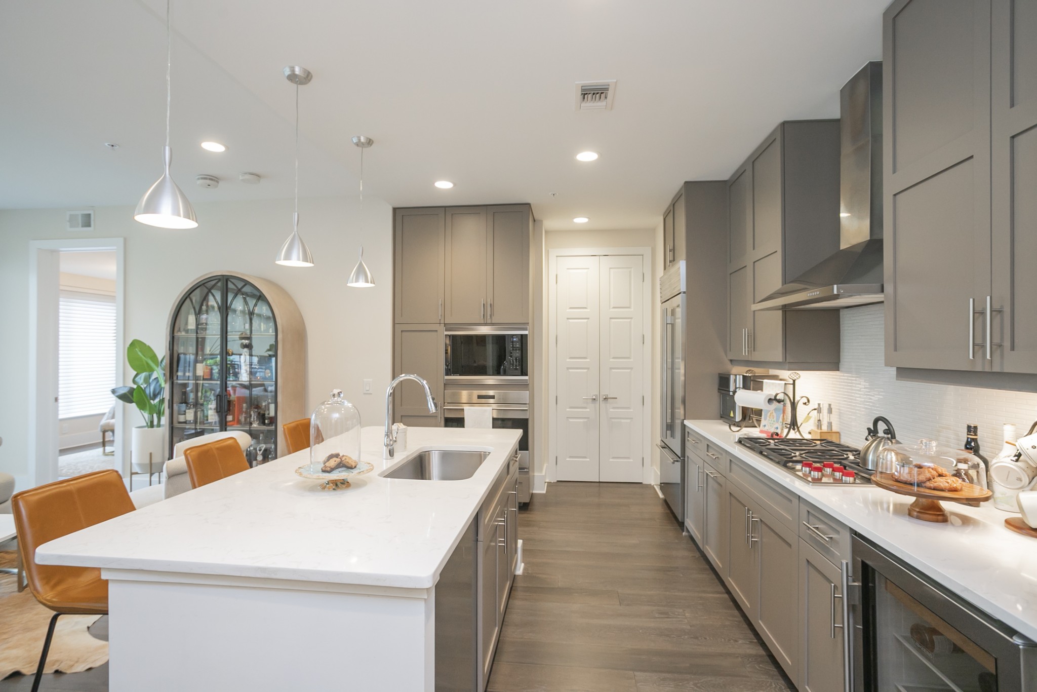 20 Rutledge Street, Unit 104 Nashville, TN 37210 - Photo 11 of 35 a kitchen with stainless steel appliances a sink a counter top space a large window and cabinets