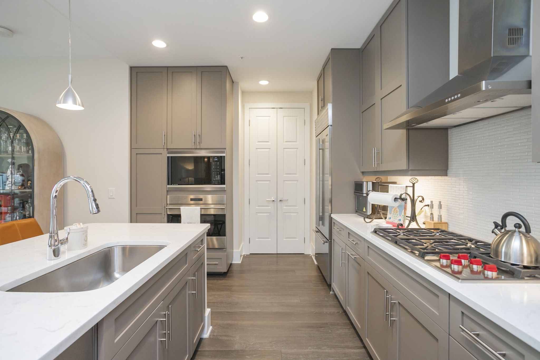 20 Rutledge Street, Unit 104 Nashville, TN 37210 - Photo 14 of 35 a kitchen with stainless steel appliances granite countertop a sink stove refrigerator and cabinets