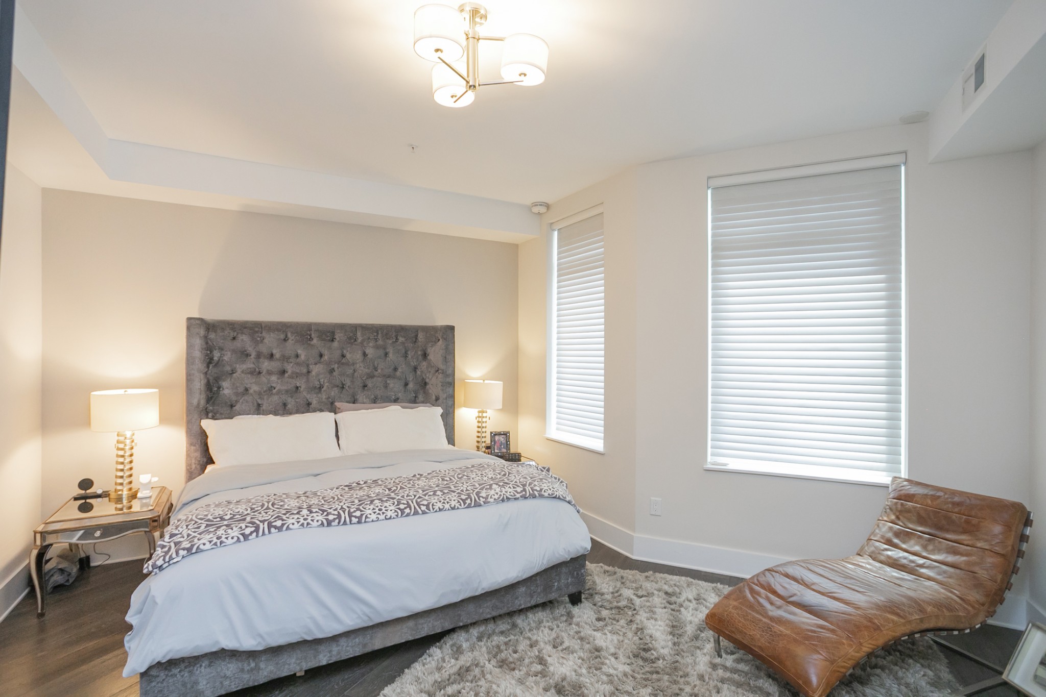 20 Rutledge Street, Unit 104 Nashville, TN 37210 - Photo 19 of 35 a bedroom with a bed and a couch