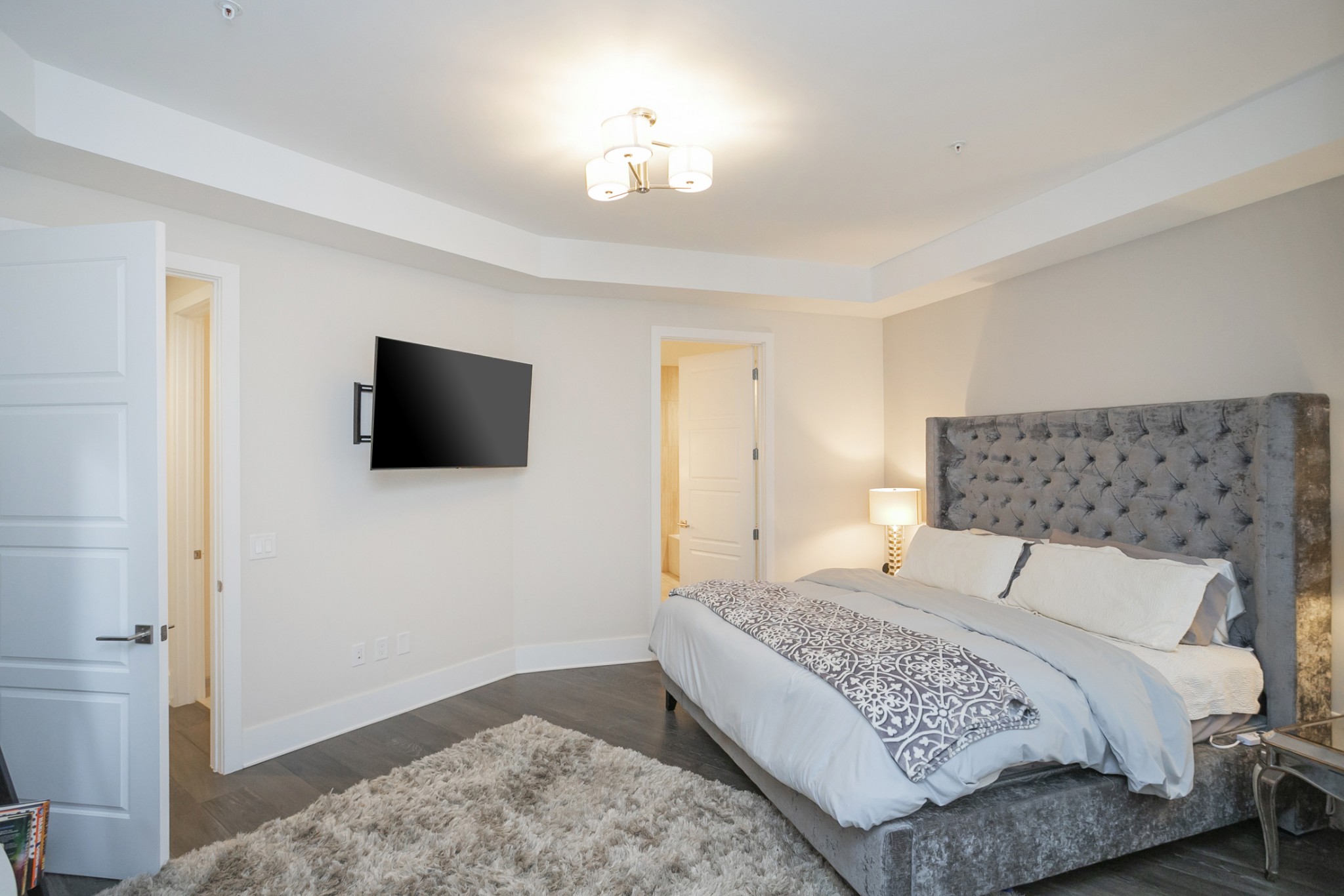 20 Rutledge Street, Unit 104 Nashville, TN 37210 - Photo 20 of 35 a bedroom with a bed and a flat screen tv