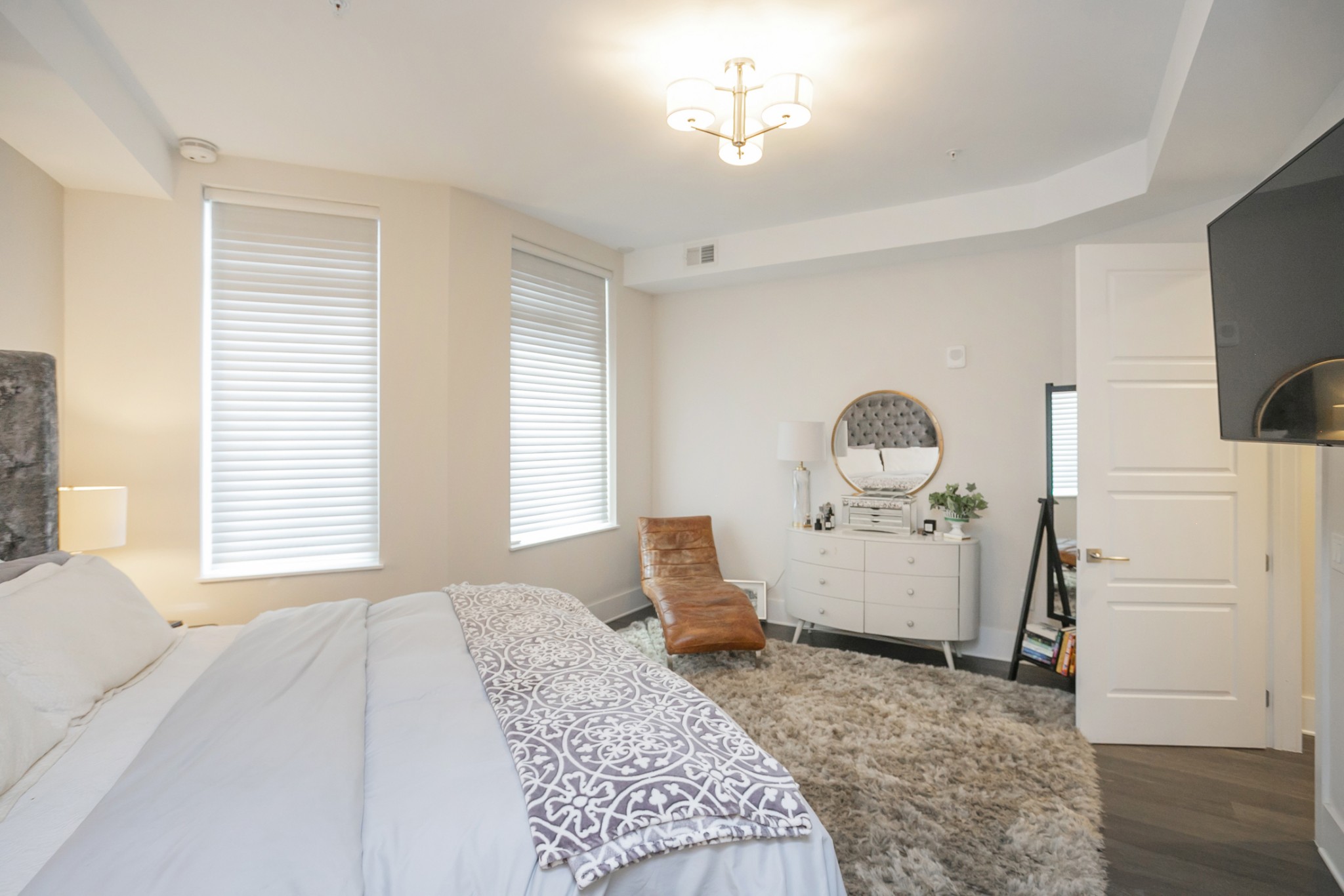 20 Rutledge Street, Unit 104 Nashville, TN 37210 - Photo 21 of 35 a bedroom with a bed and a chandelier