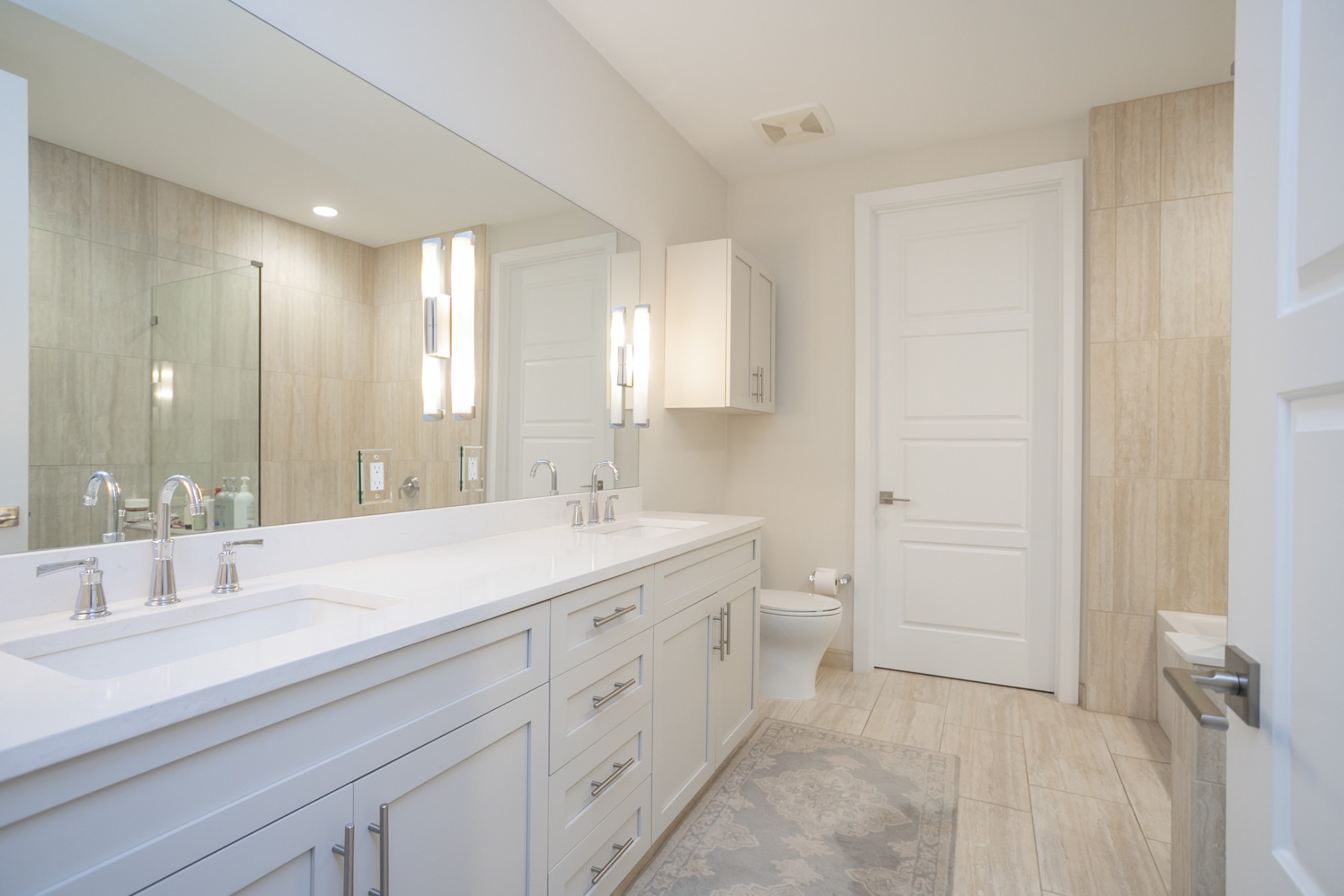 20 Rutledge Street, Unit 104 Nashville, TN 37210 - Photo 22 of 35 a spacious bathroom with a double vanity sink a mirror and a toilet