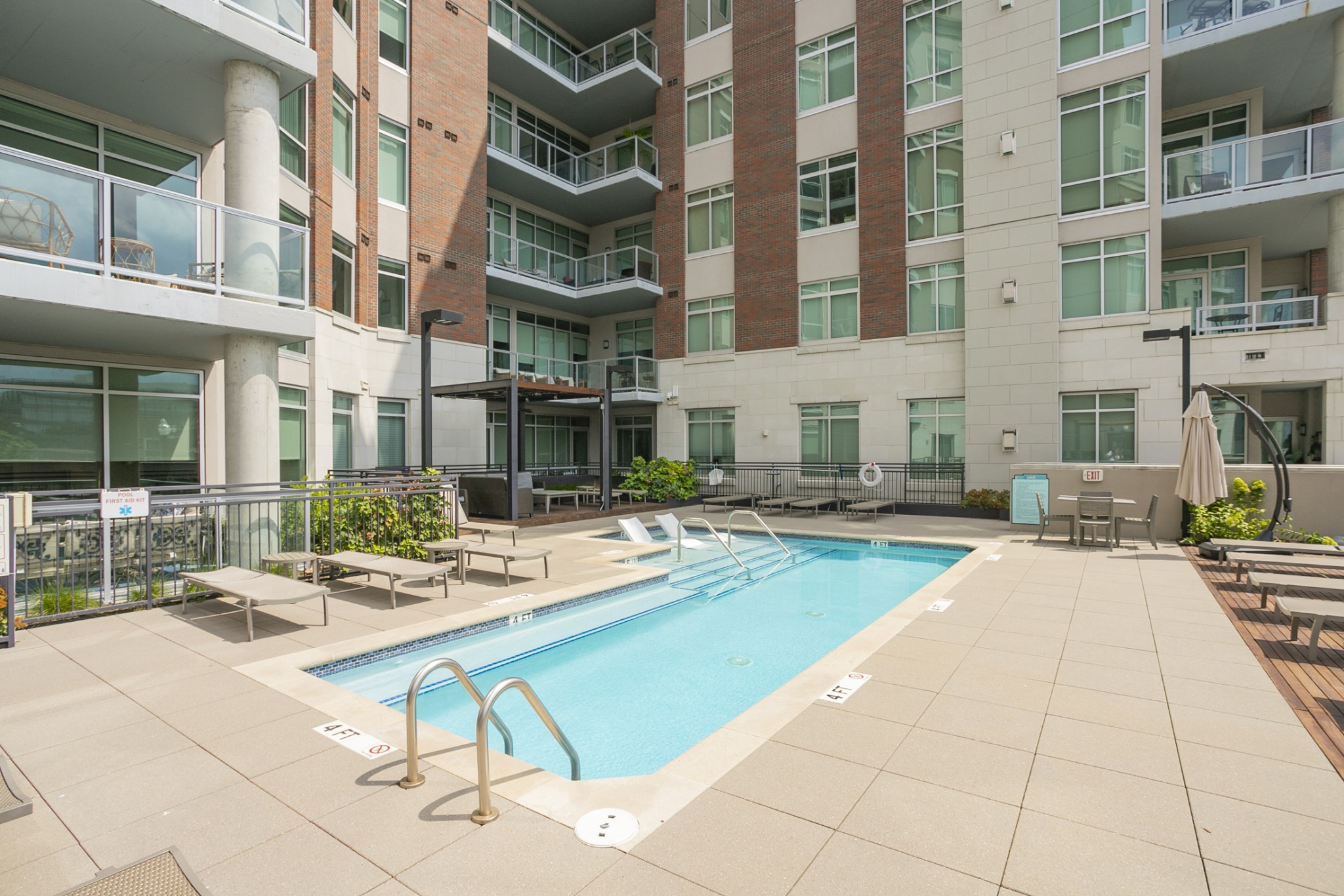 20 Rutledge Street, Unit 104 Nashville, TN 37210 - Photo 29 of 35 a view of a building with backyard tables and chairs