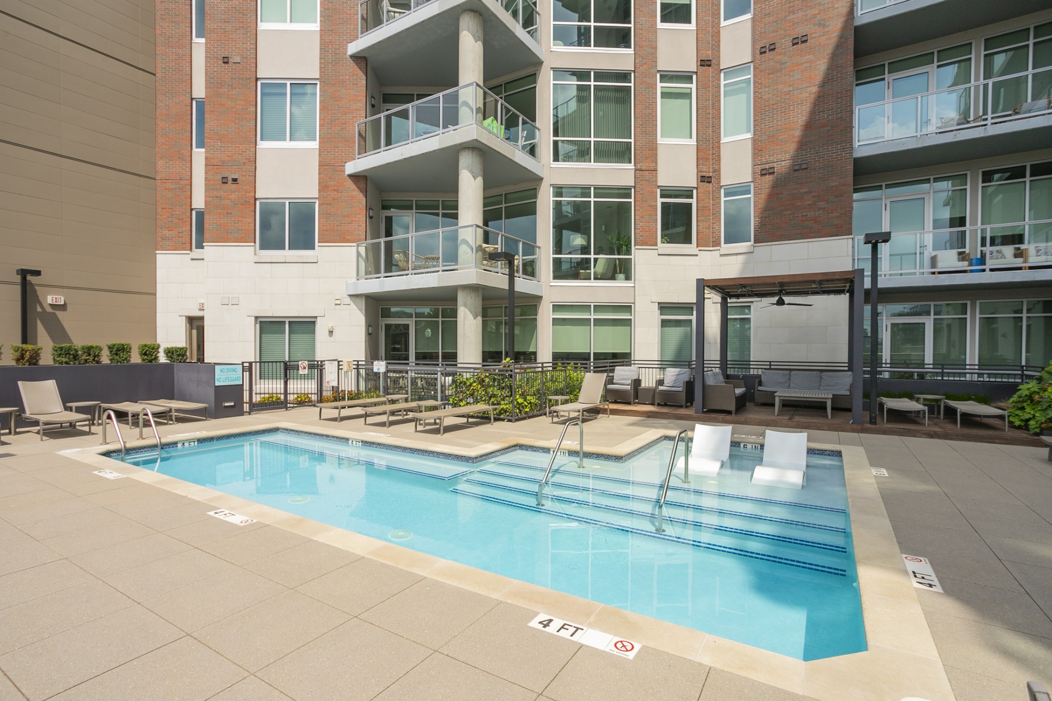 20 Rutledge Street, Unit 104 Nashville, TN 37210 - Photo 3 of 35 a view of a swimming pool with outdoor seating