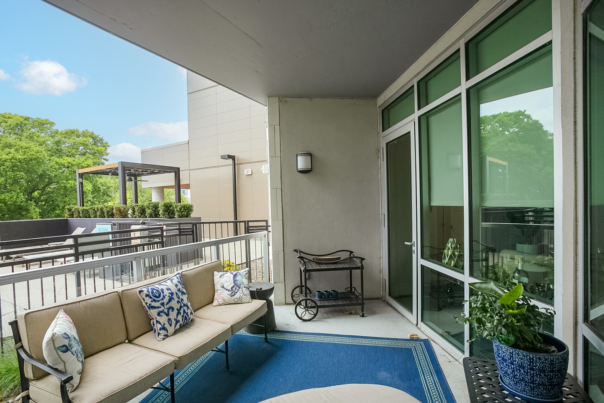 20 Rutledge Street, Unit 104 Nashville, TN 37210 - Photo 6 of 35 a balcony with furniture and a potted plant