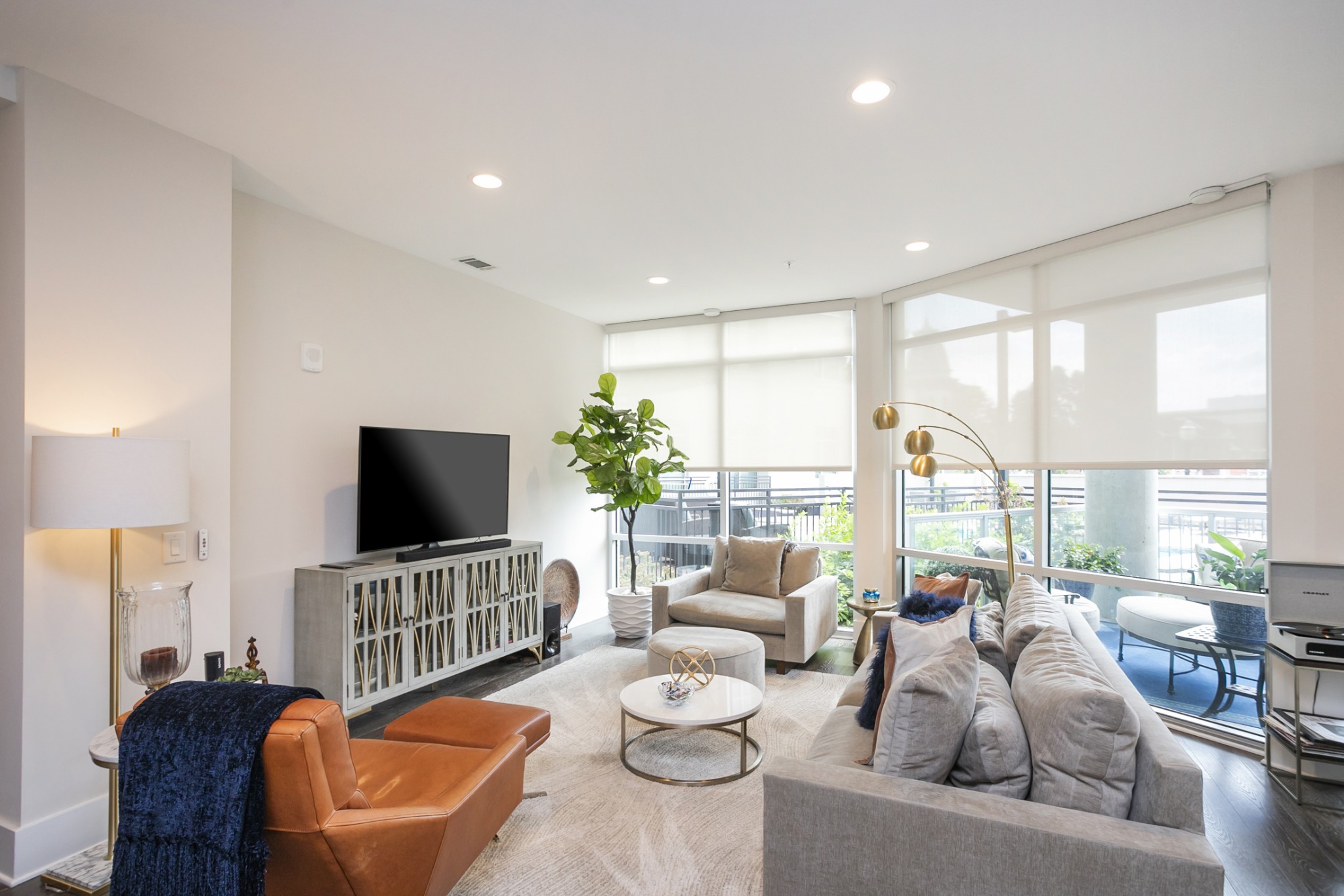 20 Rutledge Street, Unit 104 Nashville, TN 37210 - Photo 8 of 35 a living room with furniture and a flat screen tv