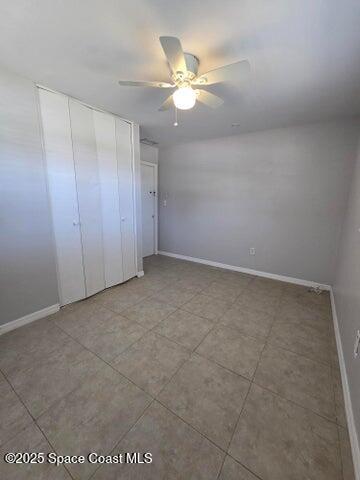2417 Delaware Drive Melbourne, FL 32935 - Photo 11 of 16 an empty room with a ceiling fan and a window