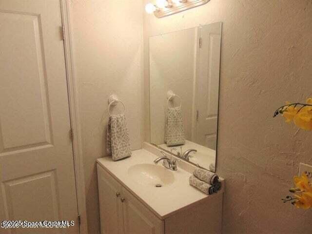 2417 Delaware Drive Melbourne, FL 32935 - Photo 13 of 16 a bathroom with a sink and mirror