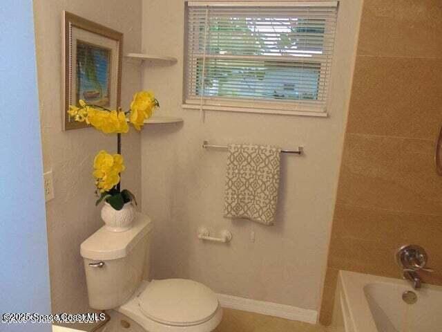 2417 Delaware Drive Melbourne, FL 32935 - Photo 14 of 16 a bathroom with a toilet sink and mirror