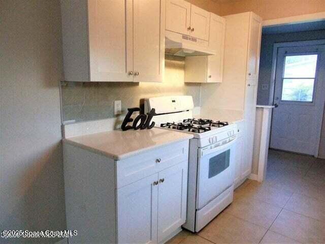2417 Delaware Drive Melbourne, FL 32935 - Photo 3 of 16 a kitchen with granite countertop a sink a stove and cabinets