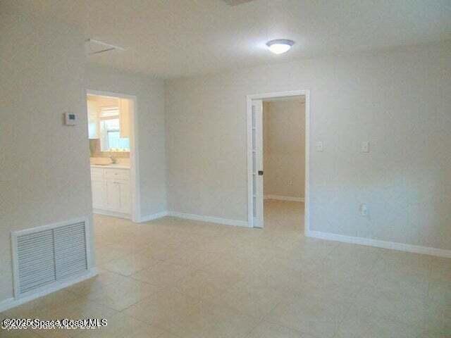 2417 Delaware Drive Melbourne, FL 32935 - Photo 7 of 16 an empty room with windows and closet