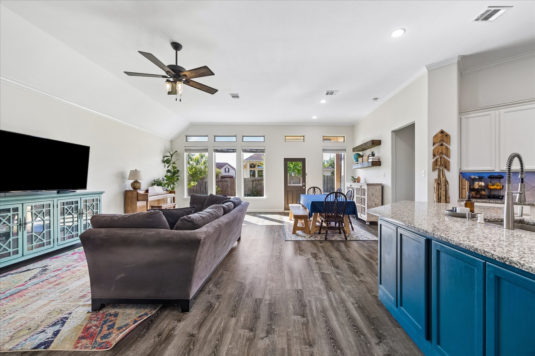 326 Ralston Ranch Court Richmond, TX 77469 - Photo 5 of 28 Clerestory windows above the garden doors flood the space with natural light. A large island anchors the seamless transition between kitchen and living areas.