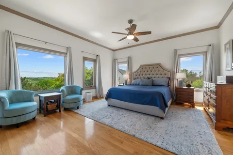 a bedroom with a bed a couch and a window