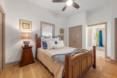 a bedroom with a bed and a chandelier