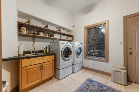 a utility room with sink dryer and washer