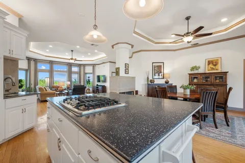 a kitchen with stove and chairs