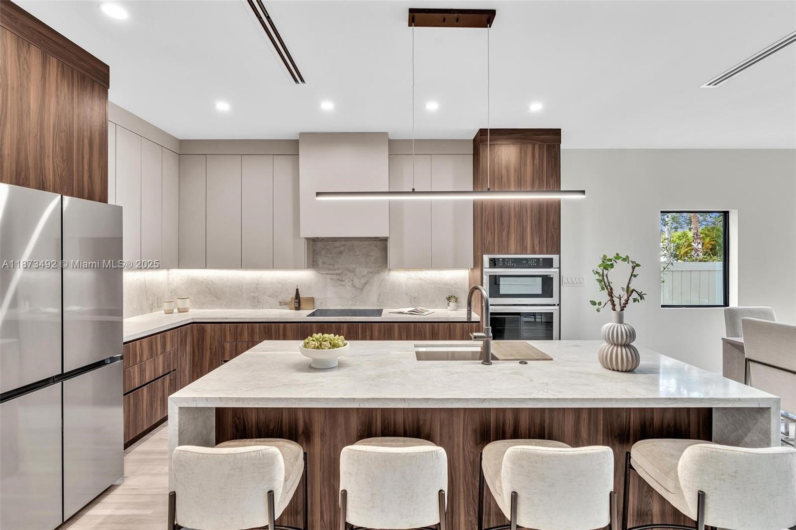 a kitchen with a table chairs refrigerator and microwave